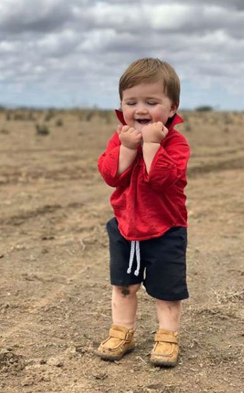 Dominique Facer posted the photo of her son's first ever taste of rain to farming Facebook page One Day Closer to Rain. 