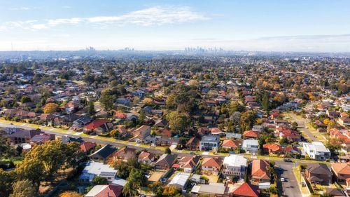 City of Ryde residential suburbs of Greater Sydney in Australia - aerial view towards distant city CBD on horizon.