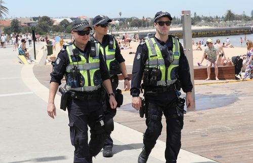 Police are seen on patrol during a hot day at St Kilda beach in Melbourne