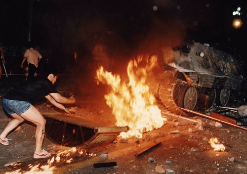 A student protester puts barricades in the path of an already burning armored personnel carrier that rammed through student lines during an army attack on anti-government demonstrators in Beijing's Tiananmen Square.