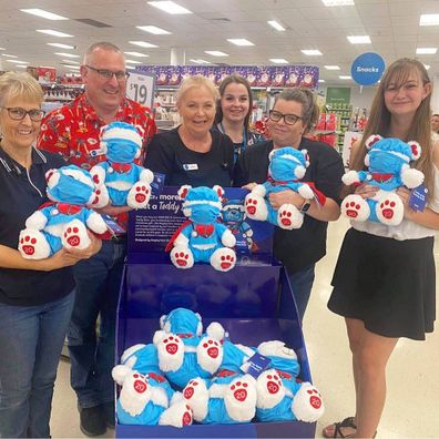 Hayley with Big W workers and her frontline worker bear