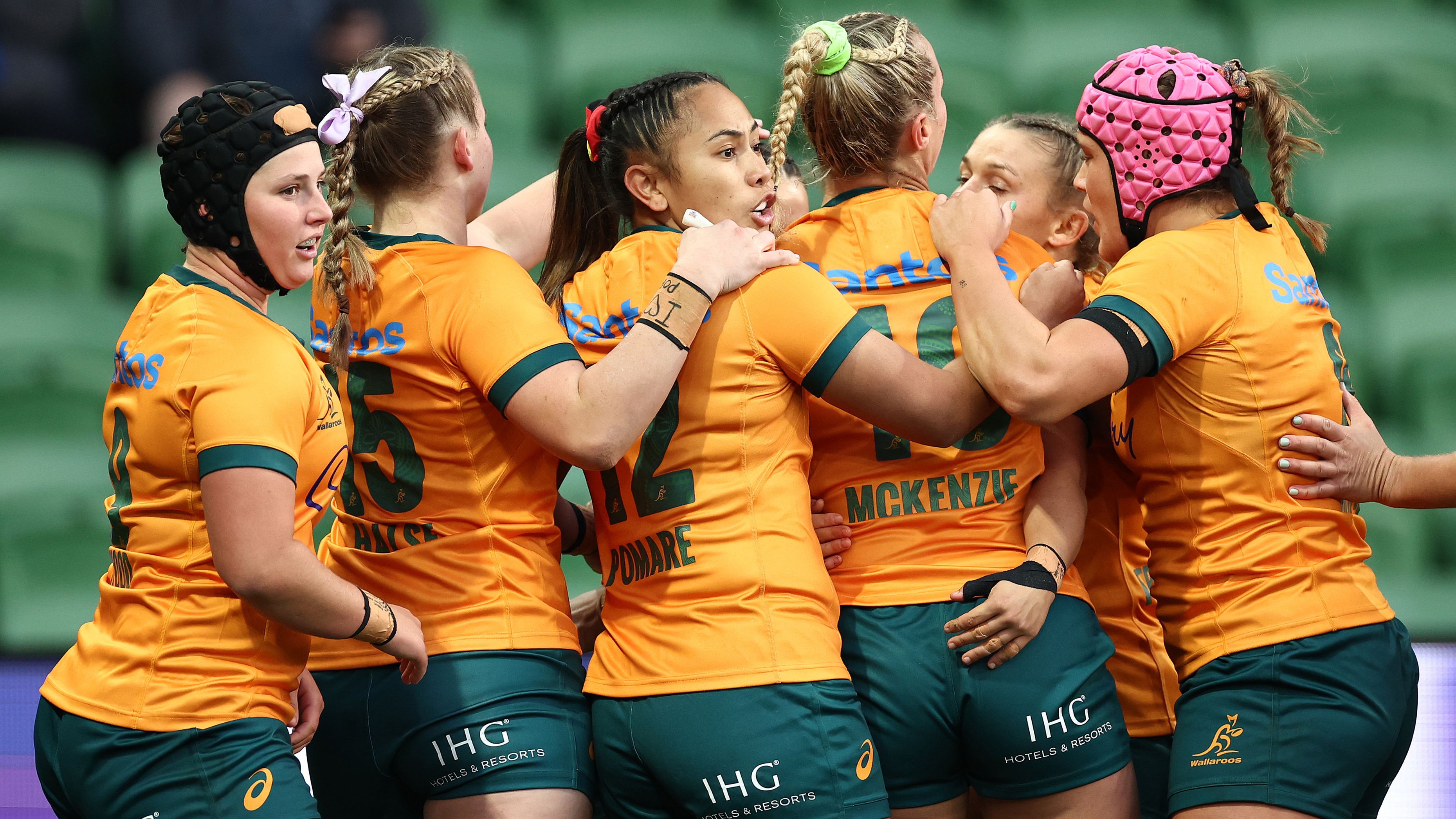 Desiree Miller of Australia is congratulated by teammates after scoring a try.