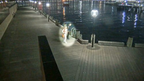 Police hope the couple walking along this wharf can help better understand the circumstances that led to the death of a Chinese student, whose body was found in Sydney's harbour.
