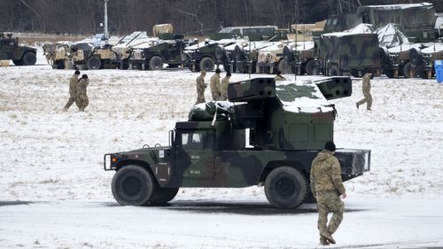 US soldiers walk at a local airport in Arlamow, south eastern Poland, near the border with Ukraine.
