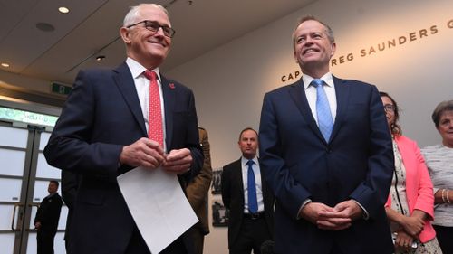 Despite the animosity between the two, Prime Minister Malcolm Turnbull and Opposition Leader Bill Shorten were all smiles today at the commemoration of the repatriation of the Long Tan Cross at the Australian War Memorial in Canberra (Image: AAP)