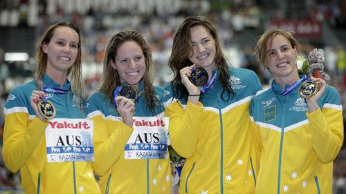 The Australian women's 4x100m freestyle relay team from left, Emma McKeon, Emily Seebohm Cate Campbell and Bronte Campbell celebrate with their gold medals at the Swimming World Championships in Kazan, Russia. (AAP)