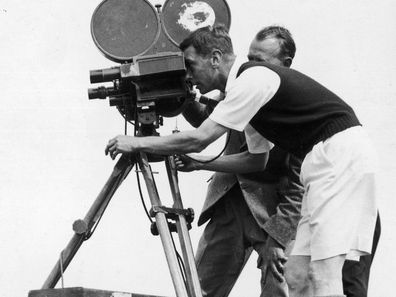 King George VI, as the Duke of York, filming with a cine camera at his camp at Southwold on August 7, 1935 (Photo by Central Press/Getty Images)
