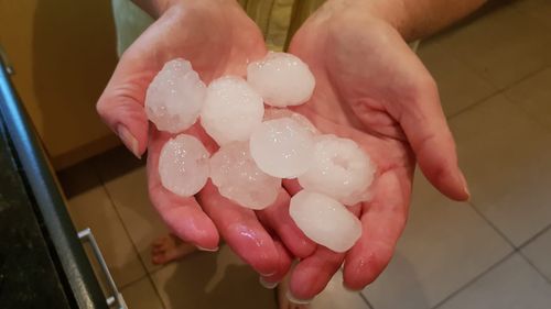 Residents in Campbelltown in Sydney's south-west collect giant hailstones. (Supplied)