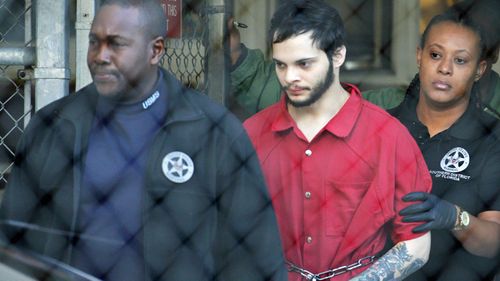 Esteban Santiago, centre, admitted shooting dead five people at Fort Lauderdale Airport after he took a gun onto a plane. (Photo: AP).