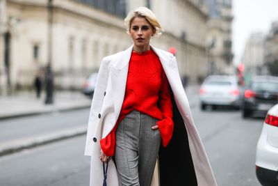Street style at Milan Fashion Week and it's all about that pop of red.