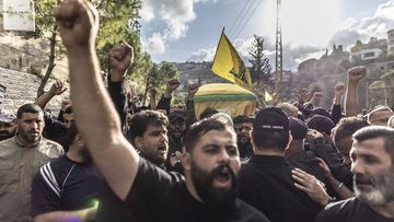 KHERBET SELEM, LEBANON - OCTOBER 18: Hezbollah supporters chants slogans against US and Israel while carrying the coffin of a Hezbollah militant killed yesterday during clashes against IDF in the southern border of Lebanon on October 18, 2023 in Kherbet Selem, Lebanon. Following the October 7 Hamas attack on Israel and ensuing retaliation from Israel on Gaza, the spectre of a second front heightened as Israel and Lebanese Hezbollah exchanged deadly gunfire. (Photo by Manu Brabo/Getty Images)