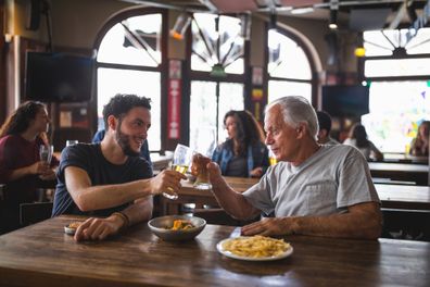 Friend watching soccer, drinking beer in the bar. Buenos Aires, Argentina