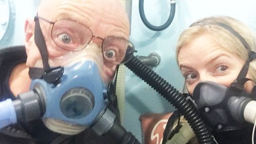 Ms Arnot has been exploring a range of treatment options. She is pictured here with her father Brian in a hyperbaric chamber in Edinburgh.