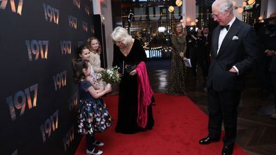 Camilla, Duchess of Cornwall receives a bouquet of flowers as she attends the World Premiere and Royal Performance of "1917" at Odeon Luxe Leicester Square on December 4, 2019 