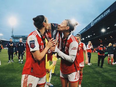 Steph Catley and fellow Matilda Caitlin Foord pose after winning the Continental Cup with Arsenal.