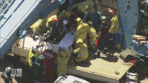 A 37-year-old man has been seriously hurt after becoming trapped inside a 100-tonne crane as it tipped in Perth's north.
It took a mammoth two hour rescue mission to save the operator whose legs were crushed.