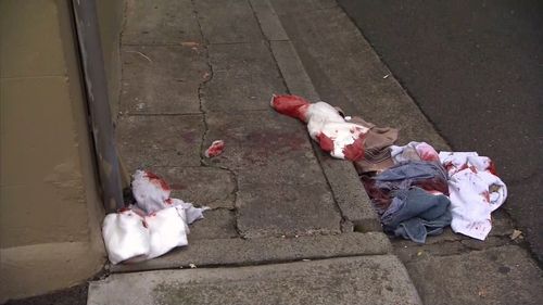 Bloodied clothes are seen strewn in Potts Point after a brutal attack with a 'box cutter like instrument.'