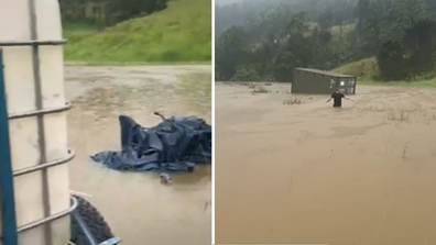 The family's water tank and shipping container has started drifting in floodwater. 