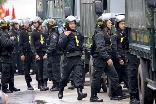 Vietnamese security stand outside the entrance to Dong Dang train station.