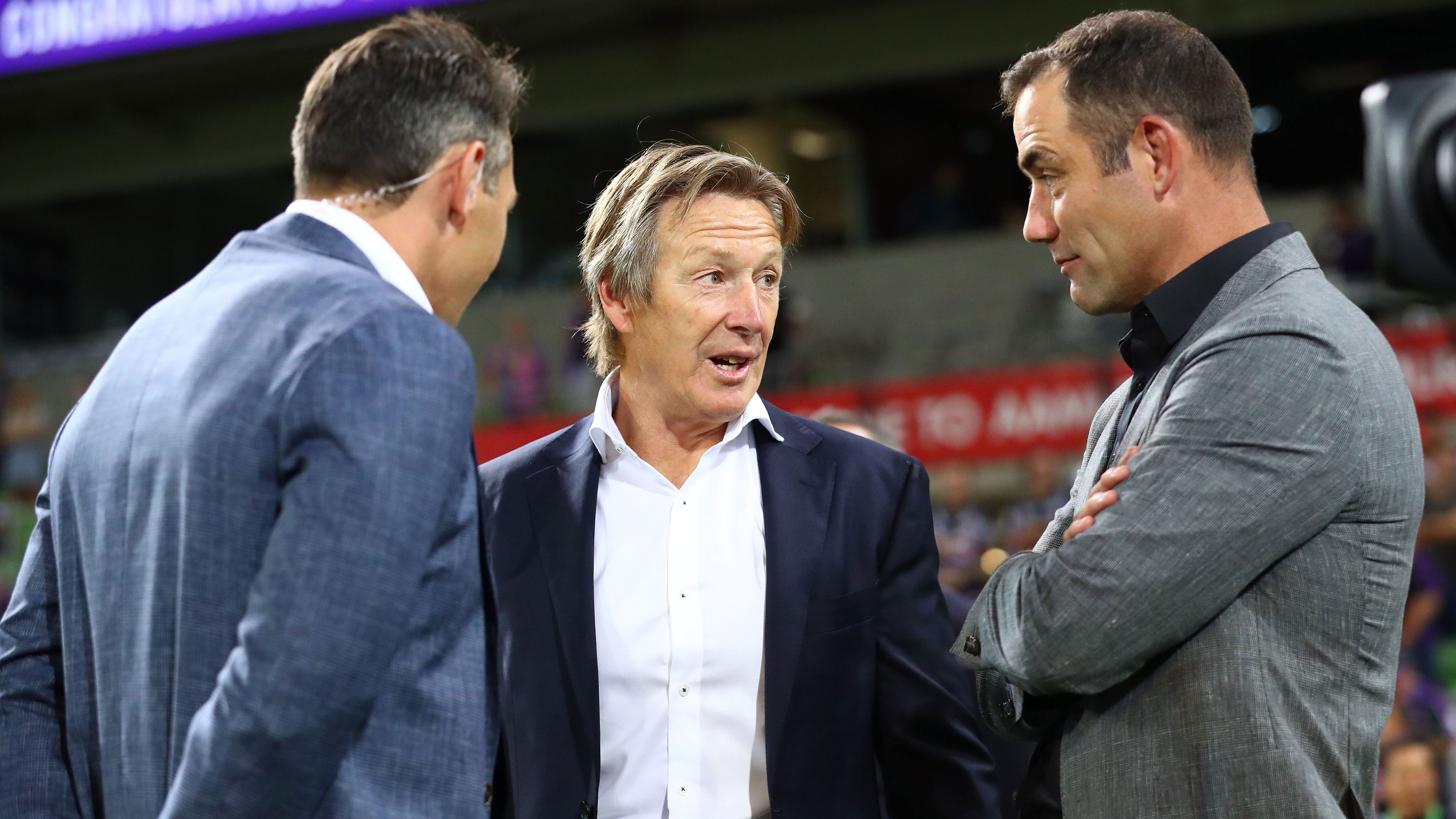Storm head coach Craig Bellamy speaks to club legends Cameron Smith and Billy Slater. 