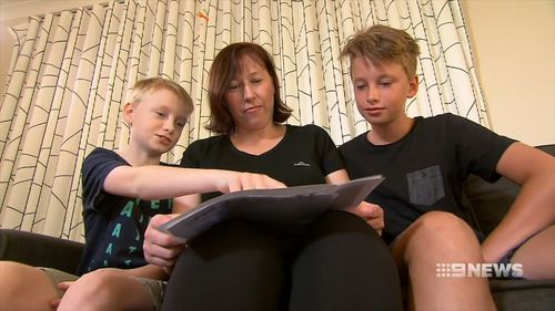 Charlee Jones at home with his mum and brother.