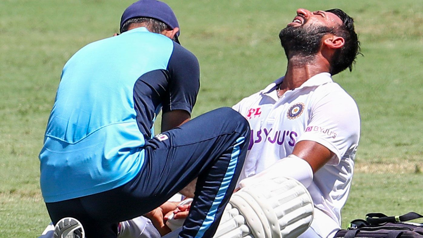 Cheteshwar Pujara receives treatment during his innings in the fourth Test.
