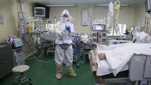 A medical staffer wearing a special suit to protect against coronavirus prepares to treat a patient with COVID-19 at the City hospital No. 52 for coronavirus patients in Moscow, Russia.