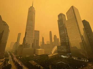 Traffic moves along West Street past One World Trade Center, Wednesday, June 7, 2023,  in New York, amidst smokey haze from wildfires in Canada. Smoke from Canadian wildfires poured into the U.S. East Coast and Midwest on Wednesday, covering the capitals of both nations in an unhealthy haze, holding up flights at major airports and prompting people to fish out pandemic-era face masks. (AP Photo/Andy Bao)