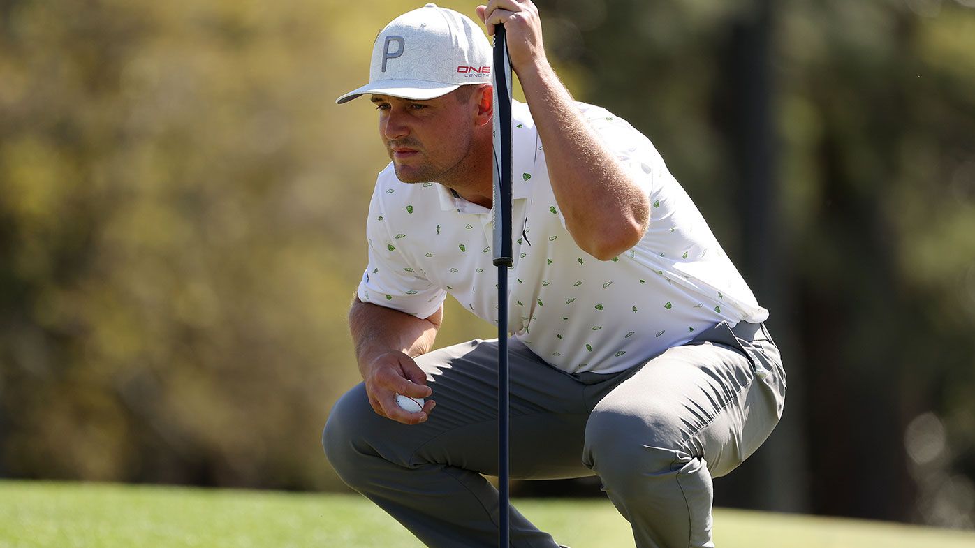 Bryson DeChambeau lines up a putt on the 18th green during the first round of the Masters
