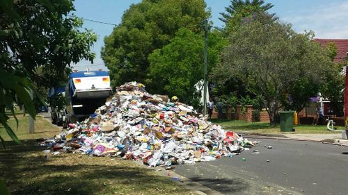 Dirty work: mountain of garbage blocks western Sydney street