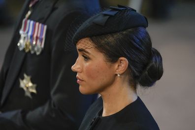 Meghan, Duchess of Sussex stands in Westminster Hall after participating in the procession of the coffin of Queen Elizabeth, London, Wednesday, Sept. 14, 2022. The Queen will lie in state in Westminster Hall for four full days before her funeral on Monday Sept. 19. (AP Photo/Gregorio Borgia, Pool)