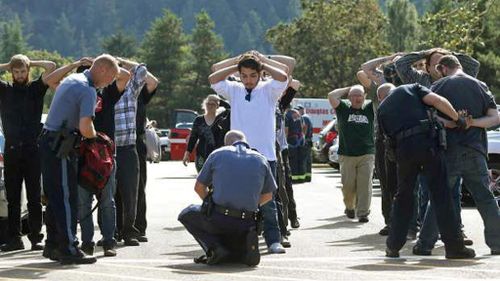 Police searching students outside Umpqua Community College. (AAP)