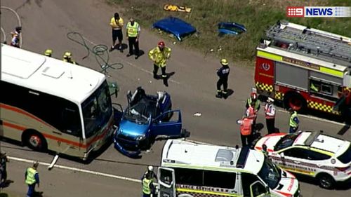 Rescue workers surrounded an accident between a bus and car in Kellyville, in Sydney's west. (9NEWS)