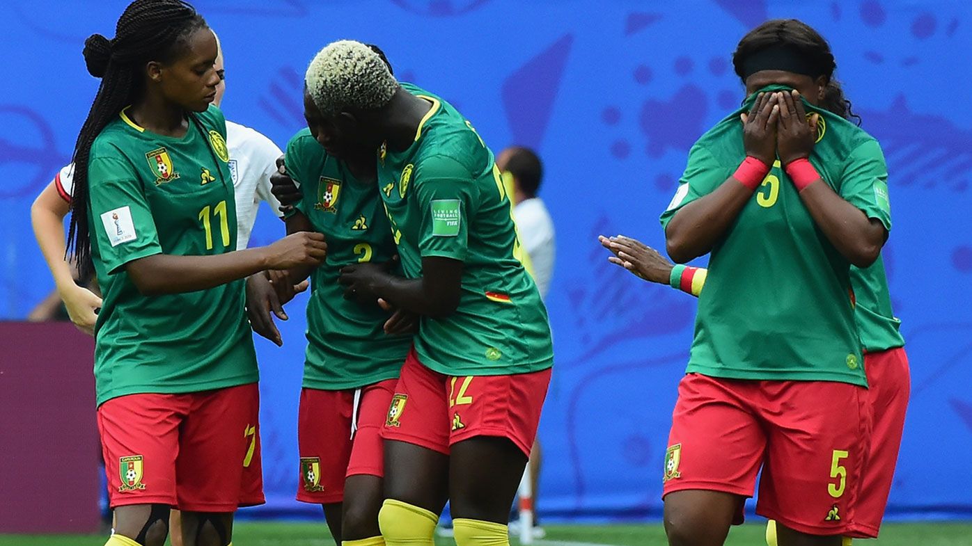 Cameroon players react to a decision during their 3-0 loss to England at the World Cup.