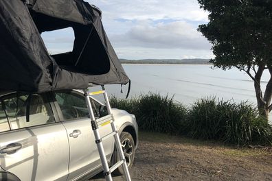 Camping in a tent atop a car