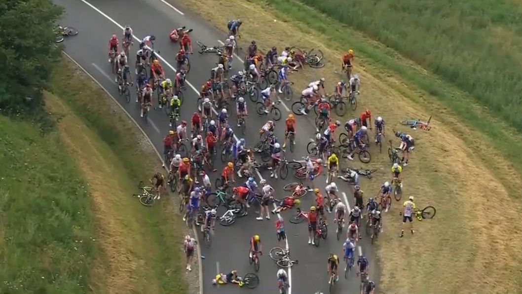 The start of the 14th stage of the Tour de France was marred by a massive pileup after a light shower slickened the road.