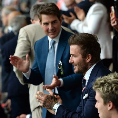 Former England international David Beckham and actor Tom Cruise applaud prior to during the UEFA Euro 2020 Championship Final between Italy and England at Wembley Stadium on July 11, 2021 in London, England. 