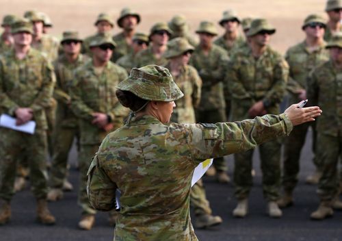 Australian Army Reserve and Regular personnel are seen during a roll call ahead of departing the Holsworthy Barracks to support bushfire efforts across NSW