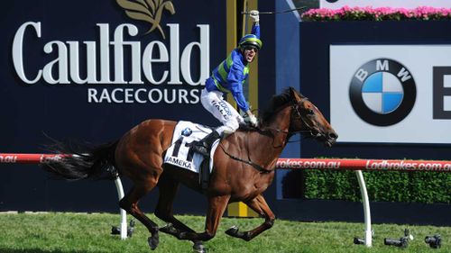 Nick Hall reacts as he rides Jameka to victory in the Caulfield Cup at Caulfield Racecourse in Melbourne. (AAP)