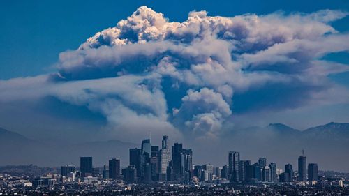 A giant pyrocumulus cloud forms above the Bridge Fire, which is burned in the San Gabriel mountains behind downtown Los Angeles this year.