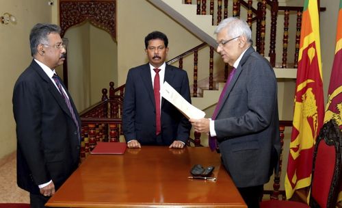 In this photograph provided by the Sri Lankan President's Office, Ranil Wickremesinghe takes oath as the interim President in Colombo, Sri Lanka, Friday, July 15, 2022. 