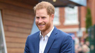 Prince Harry joins schoolchildren as they take part in a tree planting project.