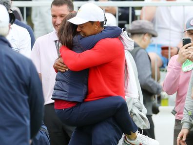 MELBOURNE, AUSTRALIA - DECEMBER 15:  Playing Captain Tiger Woods of the United States team celebrates with girlfriend Erica Herman after defeating Abraham Ancer of Mexico and the International team 3&2 during Sunday Singles matches on day four of the 2019 Presidents Cup at Royal Melbourne Golf Course on December 15, 2019 in Melbourne, Australia. (Photo by Warren Little/Getty Images)