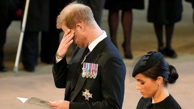 LONDON, ENGLAND - SEPTEMBER 14: An emotional Prince Harry, Duke of Sussex and Meghan, Duchess of Sussex pay their respects in The Palace of Westminster after the procession for the Lying-in State of Queen Elizabeth II on September 14, 2022 in London, England. Queen Elizabeth II's coffin is taken in procession on a Gun Carriage of The King's Troop Royal Horse Artillery from Buckingham Palace to Westminster Hall where she will lay in state until the early morning of her funeral. Queen Elizabeth II