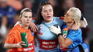 NSW Blues star Isabelle Kelly is helped off after being elbowed in the throat during State of Origin.