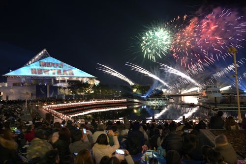 Visitors watch the fireworks display during a New Year celebration event at the Hakkeijima Sea Paradise aquarium-amusement park complex in Yokohama, southwest of Tokyo. (AAP)