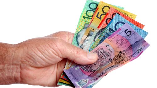 Australian dollar notes held in the hand.
