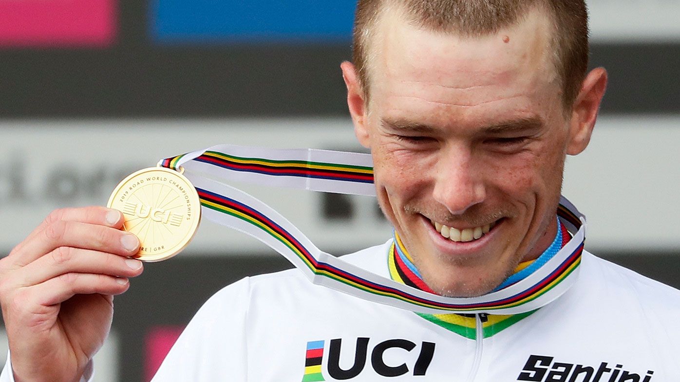 Australia's Rohan Dennis poses with his gold medal on the podium after winning the men's elite individual time trial event