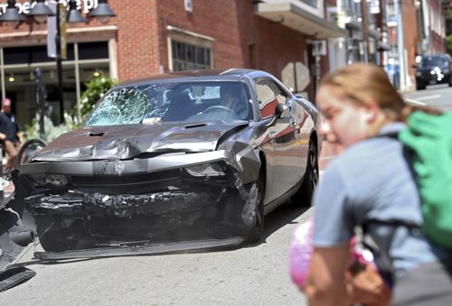 A vehicle reverses after driving into a group of protesters demonstrating against a white nationalist rally in Charlottesville, Virginia on August 12, 2017. The 2017 attack killed 32-year-old Heather Heyer and injured dozens of others. The car attack came after the rally had descended into chaos, with brawling breaking between white nationalists and counter-demonstrators. 