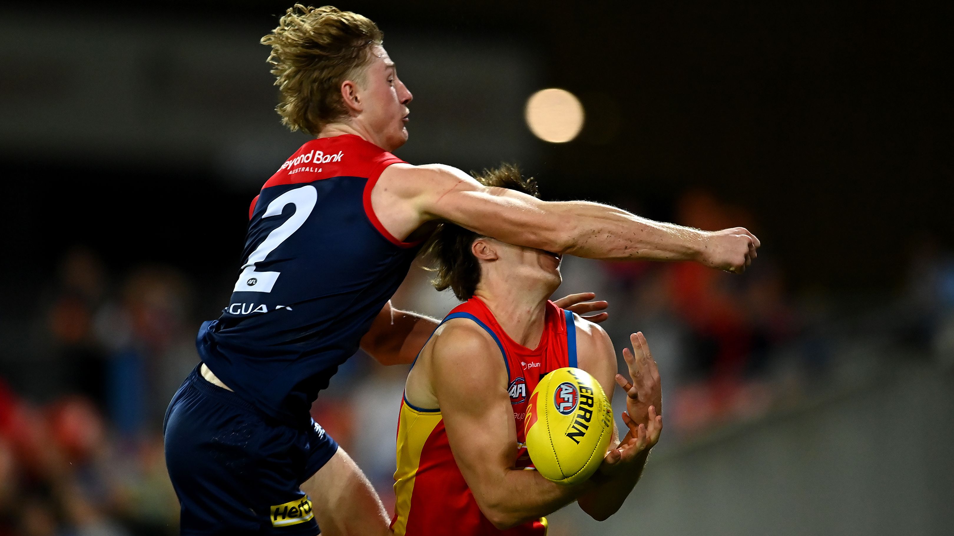 GOLD COAST, AUSTRALIA - MAY 06: Charlie Ballard of the Suns suffers an injury while challenging for the ball against Jacob van Rooyen of the Demons  during the round eight AFL match between the Gold Coast Suns and the Melbourne Demons at Heritage Bank Stadium, on May 06, 2023, in Gold Coast, Australia. (Photo by Albert Perez/AFL Photos via Getty Images)